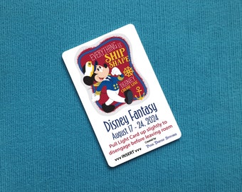 May include: A white rectangular card with the text "Everything is Ship Shape" and "Disney Cruise Line". The card features Mickey Mouse in a captain's uniform and the text "Disney Fantasy August 17 - 24, 2024".