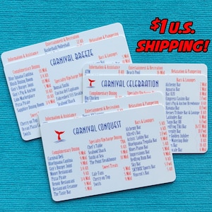 May include: Three white rectangular plastic cards featuring printed lists of ship amenities and dining venues for Carnival Breeze, Carnival Celebration, and Carnival Conquest. Each card displays blue and red text detailing deck locations and venue names.