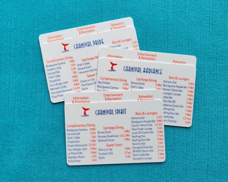 May include: Three white rectangular plastic cards featuring cruise ship deck plans for Carnival Pride, Carnival Radiance, and Carnival Spirit. Each card displays red and blue text listing dining, entertainment, and bar locations with deck numbers.