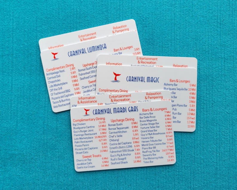 May include: Three white rectangular plastic cards featuring printed cruise ship deck plans for Carnival Luminosa, Carnival Magic, and Carnival Mardi Gras. Each card displays lists of dining options, bars, lounges, and entertainment venues with red and blue text.