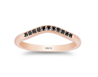 May include: Rose gold ring with a curved design, set with a row of black gemstones. The ring has a smooth, polished finish and the brand name "Iz&Co." is engraved on the inside.