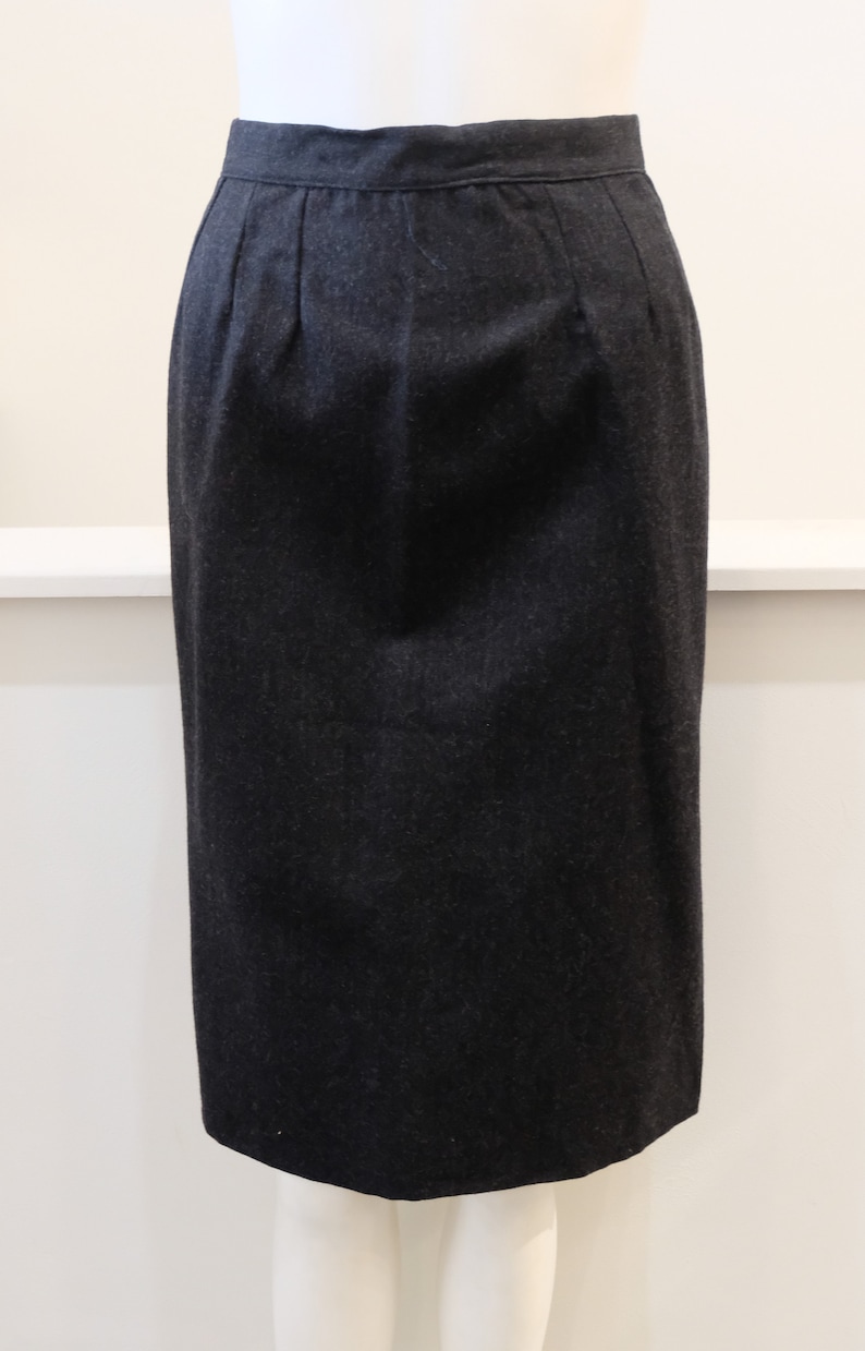 May include: A black knee-length skirt with a straight silhouette and a simple design.