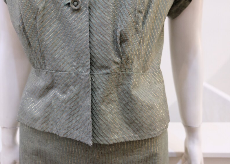 May include: A green and gold striped dress with a button-up bodice and short sleeves.