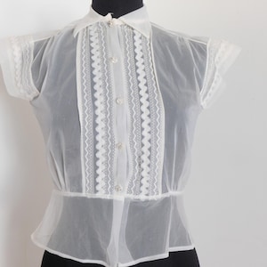 1950&#39;s vintage white nylon sheer blouse with pleat and ruffle front and button front size 2 26&quot; waist &quot;Glamour 34&quot; on Tag sleeveless