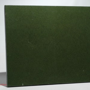 May include: A solid green board game box with a textured surface.