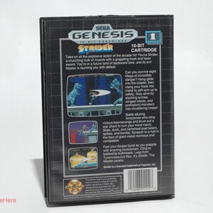 May include: A black Sega Genesis Strider 16-Bit cartridge. The back of the game case features screenshots of the game, along with text describing the game's action and features. The game is rated 1.
