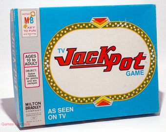 May include: A blue game box with a white and gold border. The game is called "Jackpot" and is a TV game. The box says "Ages 10 to Adult" and "Solve riddles for points and win Jackpot".