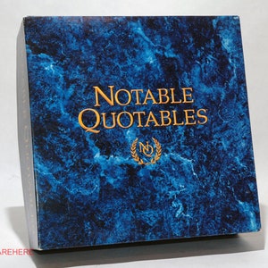 May include: A blue box with a marble pattern and gold lettering that reads "Notable Quotables".