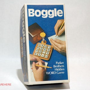 May include: A vintage Boggle word game box with a blue background and the word "Boggle" in white. The box features illustrations of hands writing and the game components. The text "Parker Brothers Hidden WORD Game" is also visible.