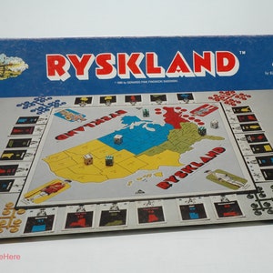 May include: A vintage Rysklan board game box with a blue background and red lettering. The game board depicts a map of the United States with various game pieces and dice. The box has a picture of soldiers and the text "Made in USA".