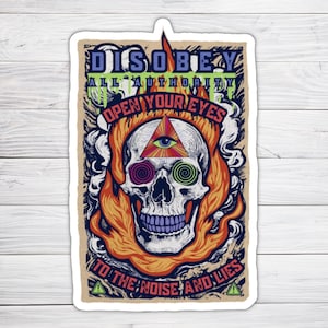 May include: A sticker with a skull in flames and the text "DISOBEY ALL AUTHORITY OPEN YOUR EYES TO THE NOISE AND LIES". The skull has a triangle with an eye in the center and swirling eyes.