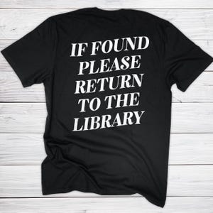 May include: Black t-shirt with the white text "IF FOUND PLEASE RETURN TO THE LIBRARY". The shirt is made of a soft material and has short sleeves. The text is in a bold, sans-serif font.
