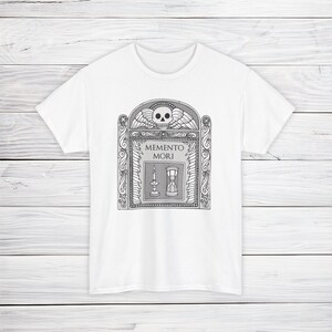Illustration of a grave stone from the 1800s with a skull, candle, and hourglass on it. States Memento Mori. Design on a t-shirt.