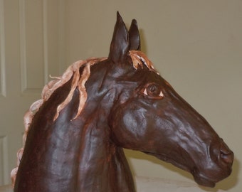 Terracotta horse head, from two different types of fired clay, on wooden base.Glazed