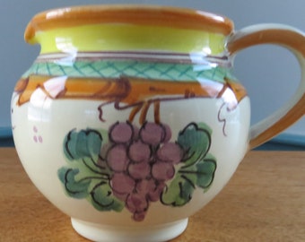 Vietri Italy 12 oz. Hand Painted Grapes Pitcher Yellow Orange Purple Teal, small glaze chip near spout, it's happy