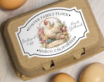 May include: A brown cardboard egg carton with a decorative label featuring a hen surrounded by flowers. The label reads "FOSTER FAMILY FLOCK," "Backyard Eggs," "Hand Gathered," and "NORCO, CALIFORNIA." Several brown eggs are visible.