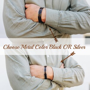 May include: Black and silver metal bracelets with engraved text are shown. The image text says "Choose Metal Color Black OR Silver". The bracelets are worn on a person's wrist, with the arms crossed.