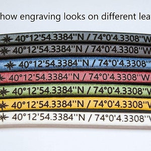 May include: A close-up of seven leather strips in different colors, each with the same engraved text: "40&deg;12'54.3384"N / 74&deg;0'4.3308"W". The text is in a black font and is centered on each strip. The leather strips are arranged in a row from top to bottom, with the darkest color at the top and the lightest color at the bottom. The colors are: dark brown, brown, blue, red, green, yellow, and white.