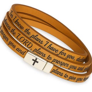 May include: Tan leather wrap bracelet with the text "For I know the plans I have for you, declares the LORD, plans to prosper you and give you hope." The bracelet has a silver clasp with a black cross.