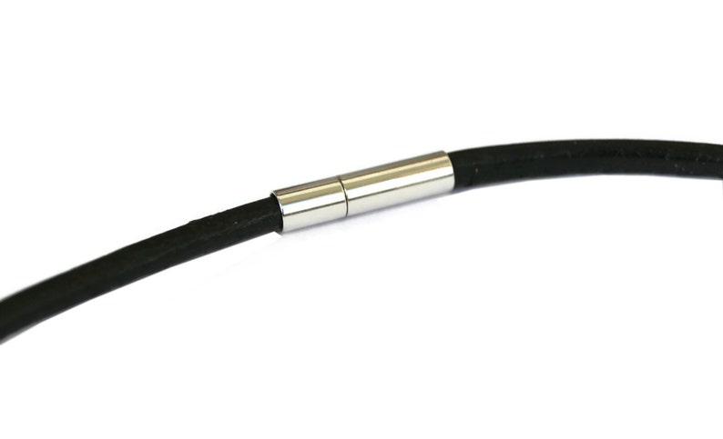 May include: A black leather bracelet with a silver magnetic clasp.