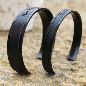matching bracelets for couples, engraved custom text, genuine leather inlay placed in a stainless steel black setting, adjustable will fit most wrist sizes