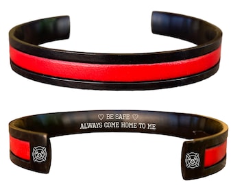 May include: Black stainless steel bracelet with a red fire department thin red line and an engraved message: "BE SAFE ALWAYS COME HOME TO ME".