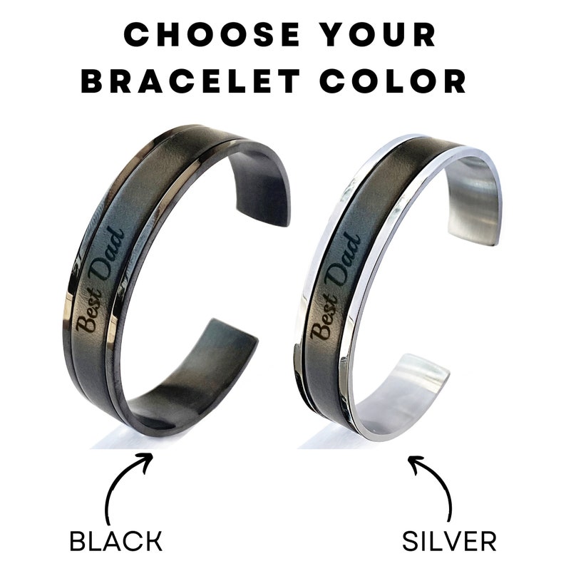 May include: Two stainless steel bracelets with a black and silver finish. Both bracelets have the words "Best Dad" engraved on them. The bracelet on the left is black and the bracelet on the right is silver.