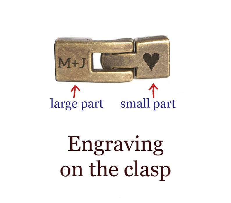 May include: A gold-toned metal clasp with an engraved heart on the smaller part and the initials "M+J" on the larger part.
