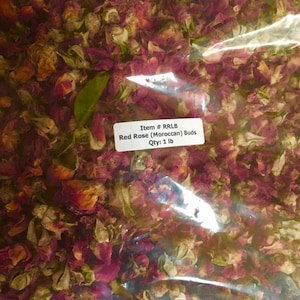 May include: A clear plastic bag filled with dried red rose buds. The bag has a label that reads "Item # RRLB Red Rose (Moroccan) Buds Qty: 1 lb".