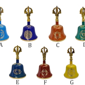 May include: Seven small, hand-held bells with a gold handle and a decorative design. The bells are painted in different colors, including blue, green, red, and yellow. Each bell features a different symbol in gold.