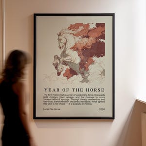May include: Framed art print featuring a white horse rearing up, with red and brown cloud-like elements. The text reads "YEAR OF THE HORSE" and describes the Lunar Fire Horse. The year 2026 is also displayed.
