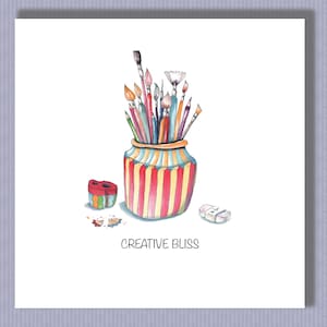 May include: A colorful striped jar filled with paintbrushes, pencils, and a pencil sharpener. The jar is sitting on a white surface with an eraser nearby. The text "CREATIVE BLISS" is written below the jar.