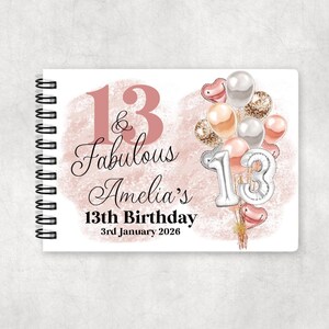 May include: A spiral-bound notebook featuring a rose gold watercolor background with the text 13 & Fabulous Amelia's 13th Birthday 3rd January 2026. The design includes a cluster of rose gold, silver, and white balloons with silver number 13 balloons.