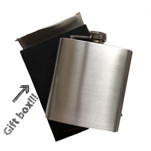 May include: A silver flask with a black pouch. The pouch has the words "Gift box!!" written on it.