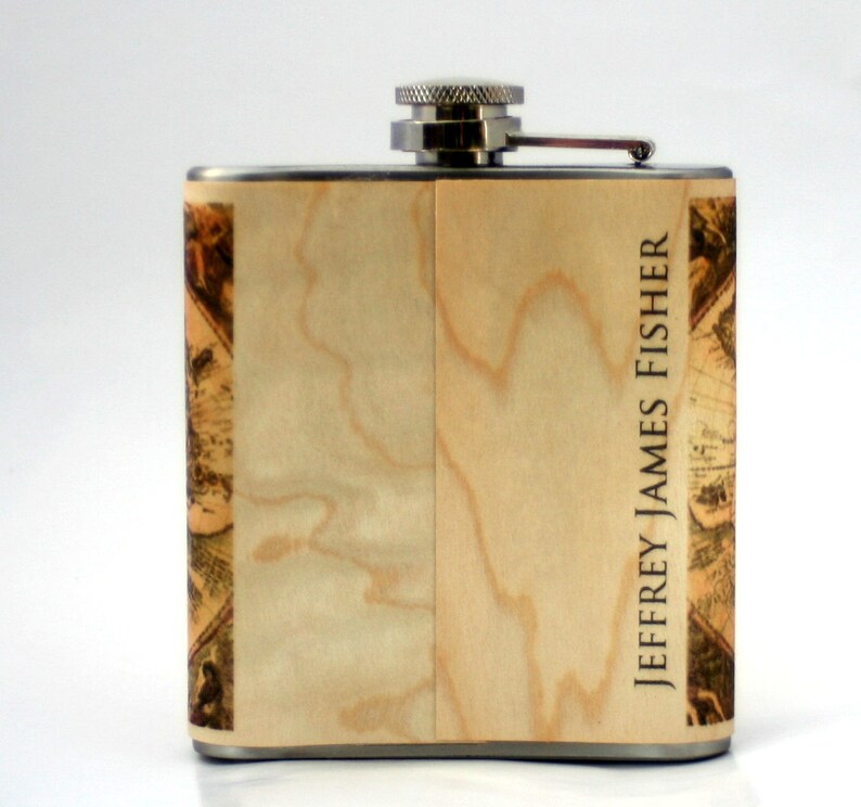 May include: A stainless steel flask with a wood grain design and the name "JEFFREY JAMES FISHER" printed on the side.
