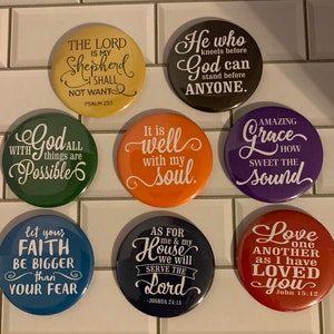 May include: Nine round buttons with inspirational quotes and scripture verses. The buttons are in various colors, including green, purple, orange, red, and blue. The text on the buttons is white.