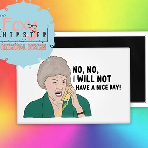 May include: A white magnet with a cartoon illustration of a woman on the phone. The woman has gray hair and is wearing a green shirt. The text on the magnet reads "NO, NO, I WILL NOT HAVE A NICE DAY!"