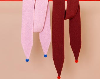 Scarf with pom poms at the ends