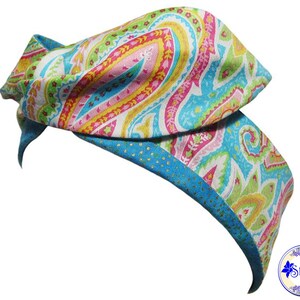 May include: A blue and white headband with a paisley pattern in pink, yellow, and green.