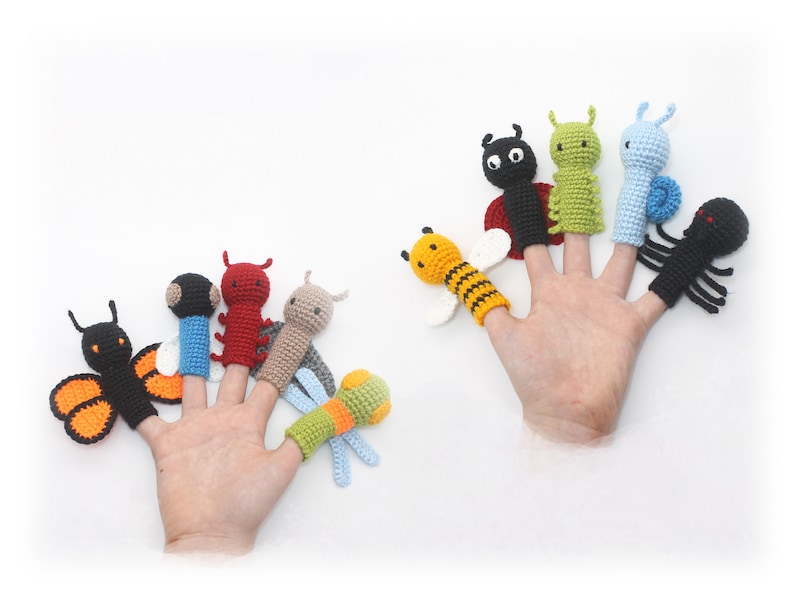 May include: A set of eight finger puppets featuring various insects, including a butterfly, ladybug, bee, caterpillar, dragonfly, and spider. The puppets are made of crocheted yarn in a variety of colors, including black, red, yellow, green, blue, and orange.