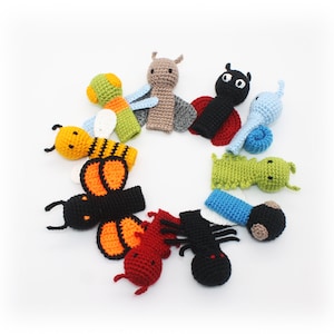 May include: A set of ten finger puppets featuring various insects, including a ladybug, a bee, a butterfly, a snail, and a caterpillar. The puppets are made of crocheted yarn in a variety of colors, including red, black, yellow, orange, green, and blue.