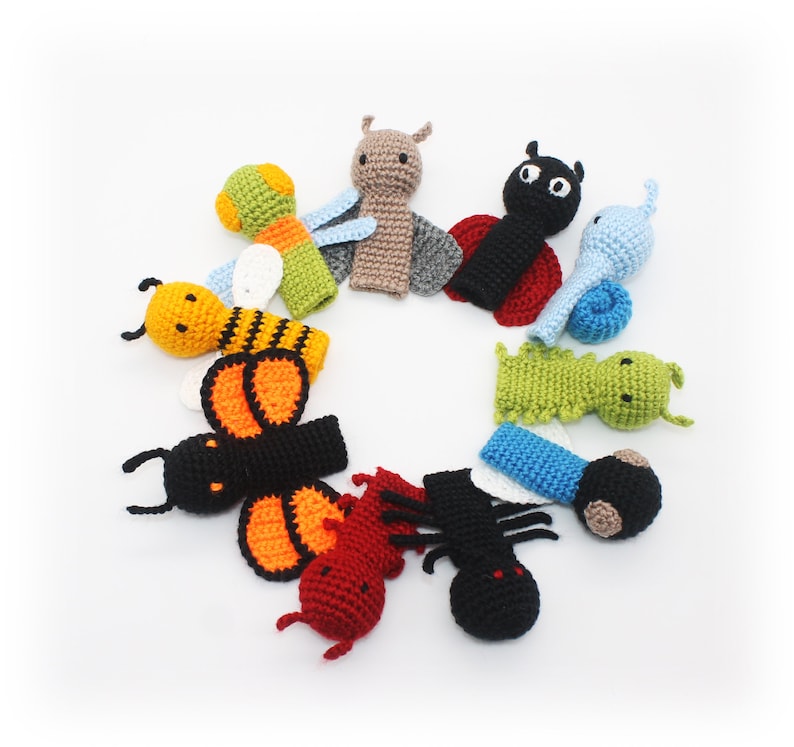 May include: A set of ten finger puppets featuring various insects, including a ladybug, a bee, a butterfly, a snail, and a caterpillar. The puppets are made of crocheted yarn in a variety of colors, including red, black, yellow, orange, green, and blue.