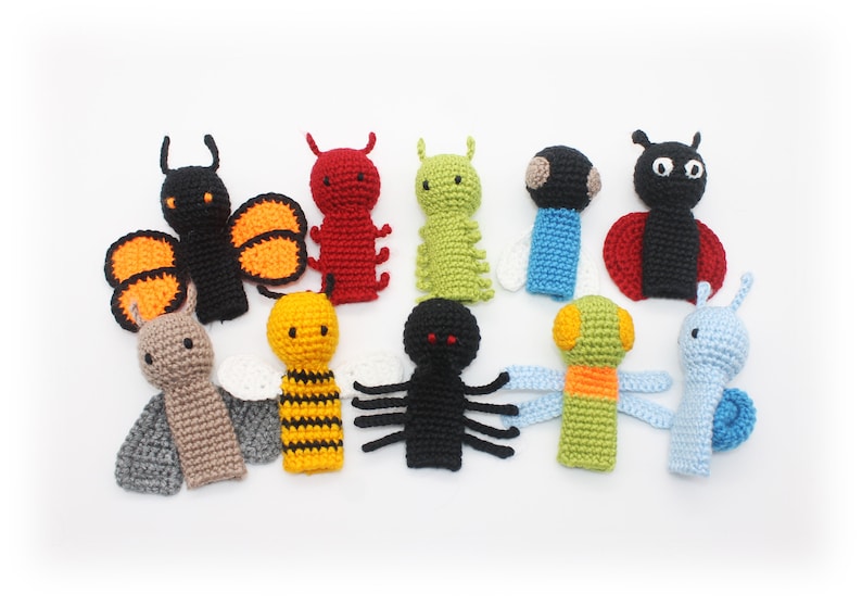 May include: Set of ten crocheted finger puppets featuring various insects, including a butterfly, ladybug, bee, spider, caterpillar, and snail. The puppets are made in a variety of colors, including black, red, yellow, green, and blue.