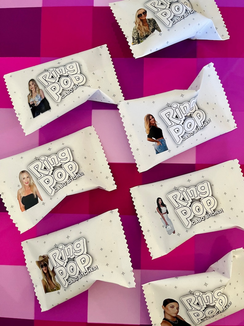 May include: A collection of white rectangular candy wrappers featuring the text Ring Pop and Cabo Bitches! alongside various photographic portraits of individuals. Each wrapper is decorated with a subtle pattern of small grey stars.