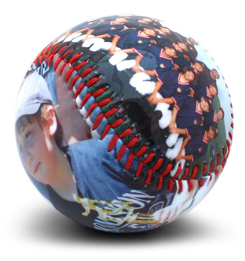 May include: A baseball with a photo of a young person and a group of people wearing blue and red uniforms. The baseball has red stitching.