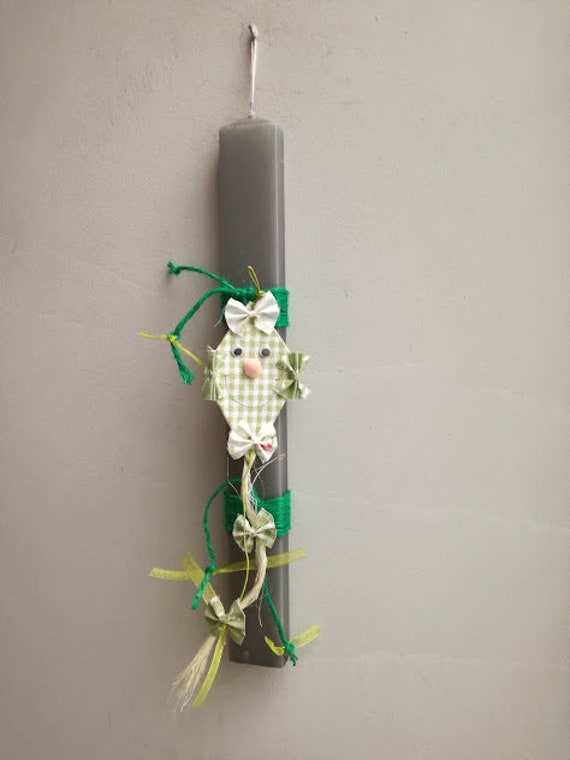 Kite Easter candle, green kite ornament on grey, Easter candle with smiling face kite, gray Greek Easter candle for kids and boys
