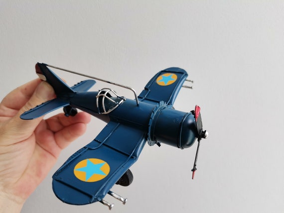 Blue metal plane, vintage, collectible miniature, retro plane with cockpit grid and moving propeller, royal blue airplane, retro aeroplane