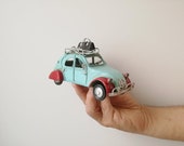 French car miniature, vintage French blue, retro collectible miniature with red fenders and baggage on the rack, blue red retro car gift