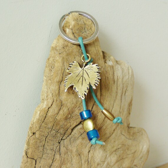 Grapevine keychain, brass grapevine leaf on a blue leather cord with brass and glass beads