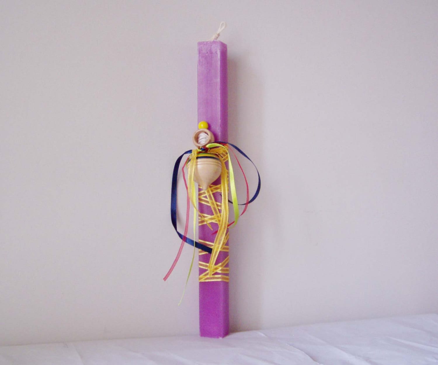Greek Easter candle with spinning top, purple, square candle with